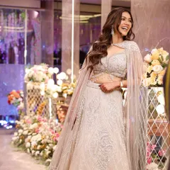 A candid moment of laughter from a Sangeet night. Her makeup is a perfect example of soft glam, with a luminous base and defined eyes that look beautiful in the festive lighting.