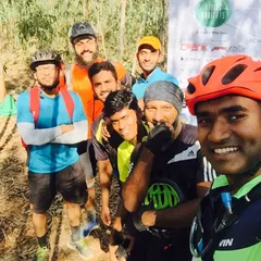 A quick selfie break during an off-road ride. You can see the mix of trail-ready bikes and happy faces, even when the path gets tough.