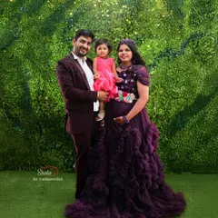 A beautiful family portrait during a maternity shoot. The mother is wearing a purple ruffle gown, and we also have options for matching outfits for the whole family.