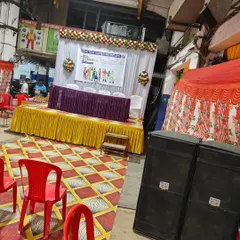 Another angle of the Labour Day event setup, showing the stage, speakers, and seating area.