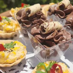 A perfect pairing for a high tea party. This platter shows our bite-sized savoury Corn Tarts alongside individual portions of rich, airy, eggless Chocolate Mousse.