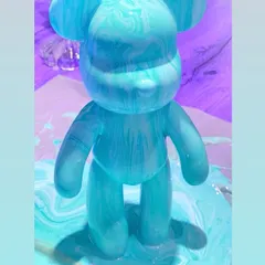 A stunning turquoise fluid bear, with mesmerizing swirls of color. This is a super fun and unpredictable art form where you pour paints to create a one-of-a-kind figurine.