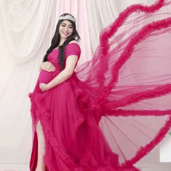 A powerful and confident pose in one of our vibrant ruffled gowns. The dramatic fabric toss adds a touch of high-fashion flair, making you the star of the show.