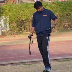 Stopwatch in hand, focused on the track. Every hundredth of a second counts, and my attention is always on the performance of my athletes.