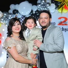 Another lovely portrait of the family at a birthday bash. Notice the coordinated outfits and the festive balloon backdrop, all part of the memories I help preserve from your special day.