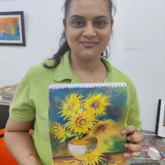 A student proudly displays her oil pastel artwork, a recreation of Van Gogh's "Sunflowers." We guide students in exploring the styles of master artists.
