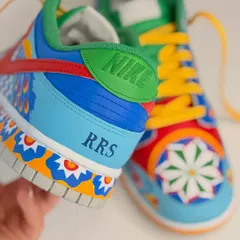 A detailed shot of the personalized heel, featuring Rishabh's initials 'RRS'. The artwork combines geometric patterns and vibrant colors, reminiscent of Indian textiles.