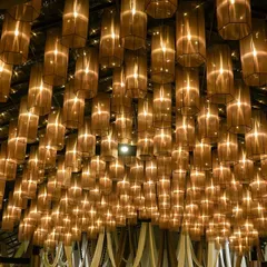 A breathtaking ceiling installation of hundreds of glowing lamps. This design creates the feeling of being under a canopy of stars, providing a truly magical and dream-like ambiance for an evening event.