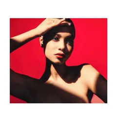 This beauty shoot was all about creating a bold, graphic look. With clean, pulled-back hair and dramatic lighting, the focus is entirely on the model's face and the vibrant red lipstick.