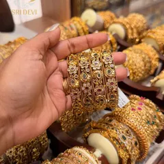 This set of four antique-style bangles features a delicate floral design with multi-colored stones. They are perfect to wear as a set or to mix with other glass bangles for a heavier look.