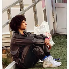 A pensive image of Olympian Sakshi Malikk, a warrior for justice alongside Vinesh Phogat. The line "Lambi hai gam ki sham lekin sham hi toh hai" reflects the long but hopeful struggle for justice.