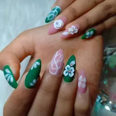 This matte-finish set combines green and pink nails with intricate white line work and beautifully sculpted 3D flowers.