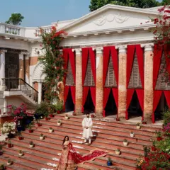 Another stunning shot from Oishi and Arpit's Vogue feature. The grand red drapes on the steps of the Rajbari Bawali created a dramatic, regal backdrop that was truly unforgettable.