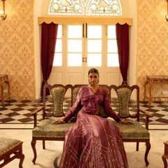 For this brand campaign, we chose a heritage palace to create a sense of timeless royalty. This wide shot was designed to showcase the grandeur of the location and the elegance of the couture gown, making the model appear regal and poised within a magnificent setting.