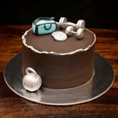 The perfect cheat day cake for a fitness lover. This chocolate cake is decorated with a fondant gym bag, dumbbells, and a kettlebell, all handcrafted to look like the real thing.