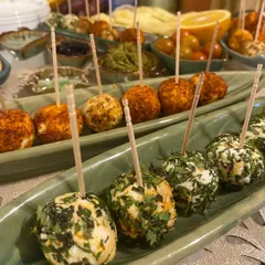 A closer look at our mini cream cheese rolls, seasoned with Paprika Garlic and Parsley Walnut. Each one is a perfect bite-sized appetizer, ideal for mingling and sharing at parties.