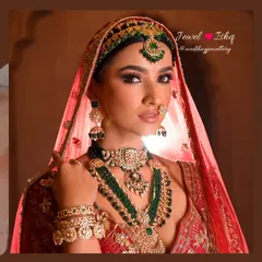 This is the ultimate royal bridal look. A heavily layered Kundan and Polki set with deep green emeralds, complete with a traditional mathapatti, jhumkas, and nath. Every piece is designed to make you feel like a queen on your wedding day.