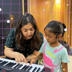 One on one guidance is key to building confidence. Here, one of our mentors works with a young pianist, making sure she understands the notes and feels comfortable at the keyboard. We believe in patient, personalized teaching for every child.