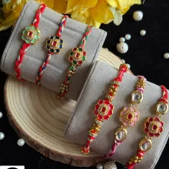 A beautiful collection of single rakhis featuring colorful floral kundan work. Each piece is unique, with vibrant enamel and stone details on a hand-braided thread.
