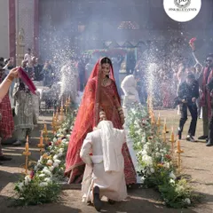 Capturing the joy of the Jaimala ceremony. This moment is enhanced by our stage setup, featuring a flower-lined aisle and cold pyro effects that add a touch of drama and celebration to the bride's entrance.