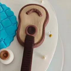 The detail on the fondant guitar. Even the smallest elements are crafted with precision and care to ensure the final cake is a perfect representation of the person it's for.