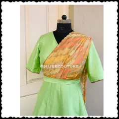Here is a closer look at the bodice of the green silk gown. You can see the clean V-neckline and how the printed dupatta is seamlessly integrated into the design. The delicate lacework on the sleeve edges adds a simple, elegant touch to the final piece.