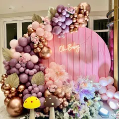 This enchanted garden theme is all about the magical details. I combined shades of mauve, pink, and rose gold with a custom "Oh Baby" neon sign, whimsical mushroom props, and a base of artificial flowers to create a fairytale photo corner.