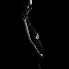 A similar silhouette pose, capturing a gentle smile and a feeling of serene anticipation.