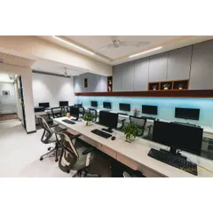 Another perspective of the open workspace, showing the clean lines of the custom storage units and the bright, even lighting that creates a productive environment for our team.