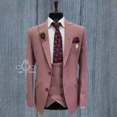 A dusty rose three-piece suit that challenges traditional formal wear. Paired with a floral tie, this is a confident and stylish choice for a daytime wedding or a special event where you want to stand out.