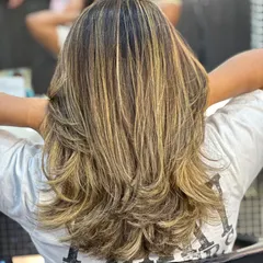 This is one of my most requested looks: a combination of a layered haircut with expertly blended global highlights. It creates a sun-kissed, dimensional effect that looks effortlessly gorgeous.