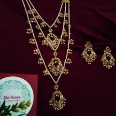 My 'Triveni' necklace set, a pre-layered masterpiece for that complete, regal look. This limited edition piece combines three distinct layers of Jadau and pearl work, creating effortless grandeur.