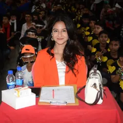 Here I am at the judging table, surrounded by the vibrant energy of the student audience at St. Anne's. We use a structured evaluation sheet to ensure our scoring for choreography, expression, and overall impact is fair and consistent.