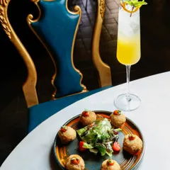 An artistic shot of magic mushrooms and a cocktail, using the restaurant's elegant decor to create a sophisticated atmosphere.