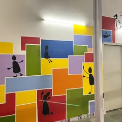 This colorful mural at a school in Dharavi was about painting hope and joy. The simple stick figures playing against a backdrop of bright blocks represent the power of community and play.