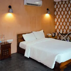 Our yurt-style cottages feature modern comforts and an understated elegance, with a comfortable double bed and warm lighting for a cozy stay.