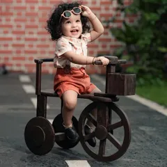 This little boy is ready for his ride! We love capturing the happy and playful moments of toddlers exploring our outdoor props.