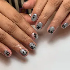 This client was heading to Switzerland and wanted her nails to tell the story. I hand-painted tiny airplanes, mountain silhouettes, and map routes on a cool grey base to capture her travel excitement.