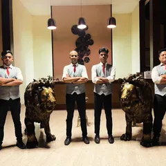 A smaller, dedicated team of our bartenders posing in a hotel lobby before an event. Whether the event is large or small, we provide the same level of professional service.