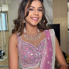 A bright, happy smile from this wedding guest. The hairstyle features a simple twist at the back, keeping the front pieces neatly away from her face.