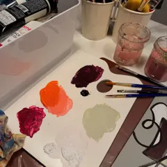 A shot of my paint palette next to an abstract piece I was working on. This image is tied to a personal realization about breaking free from the need for perfection and giving myself permission to create without rules or expectations.