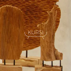 This image shows a grouping of my handcrafted wood artifacts. The different textures, from ribbed carvings to smooth, natural driftwood forms, create a visually rich display.
