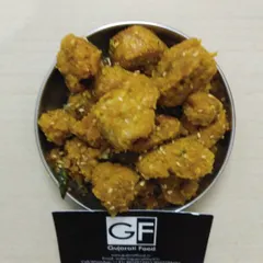 A bowl of my crispy fried Muthiya. These are savory dumplings made from chickpea flour, fenugreek leaves, and spices, making for a delicious and crunchy snack.