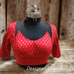 This red brocade blouse features a modern halter-style neckline with sleeves. It's a trendy design that can be customized to suit your style.