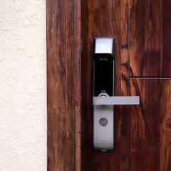 Experience the convenience of keyless entry with our smart digital lock installations. This sleek lock, fitted on a solid wood door, demonstrates how we provide secure, app-controlled access that enhances your home's aesthetic.