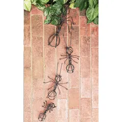 These wireframe ant sculptures, crafted from recycled materials, climb a brick path in our studio. They represent teamwork and persistence, values that are central to our architectural practice.