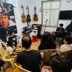 Another view of our jam session, showing students performing for a supportive crowd. This experience is invaluable for building the confidence to play in front of others.