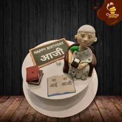 I made this special cake to celebrate an "Aaji" (grandmother). It features a sweet fondant figure of a grandmother teaching, complete with a book and a small blackboard, honoring her wisdom and love.