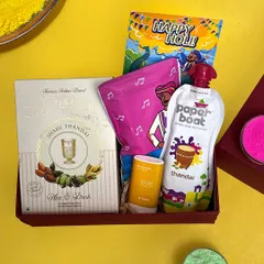 A close-up of another one of my affordable Holi hampers. This one includes Shahi Thandai mix, a packet of gulal, a pouch of Paper Boat thandai, and a small jar of Chandan tika.