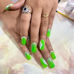 A neon green set that's sure to turn heads. The design includes a glitter ombre effect, 3D white flowers, and rhinestone details for extra sparkle.